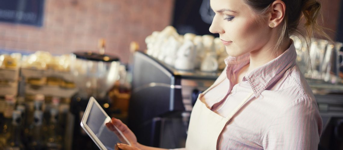 Side view of waitress with digital tablet